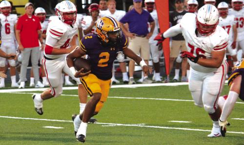 La Grange quarterback Jaden Williams looks for running room Friday. Photos by Jeff Wick