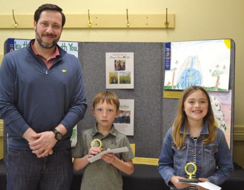 Poster Contest (Division 1; Grades K-2): Cason Peschke (Sacred Heart School) and Sylvia Shimek (Sacred Heart School); presenter: Bryan Minzenmeyer of Fayetteville Bank.
