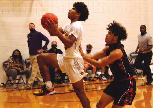 La Grange’s Bravion Rogers drives to the basket for part of his game-high 19 points Tuesday as Schulebburg’s Manny Herrera is on defense. Photos by Jeff Wick