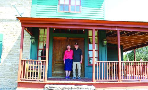 The Crawfords in front of home they have with restored, with the original doors still in place! Photo by Jessica Montez