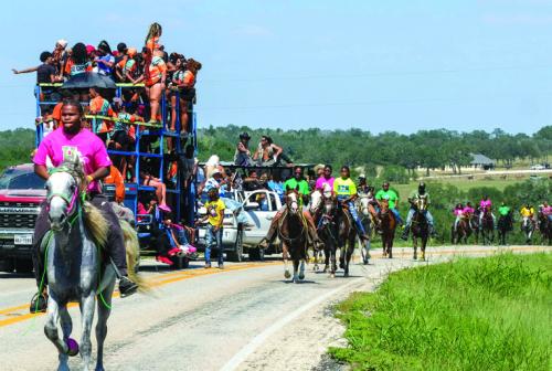 Part of the Real Deal Trail Ride makes its way down FM 2145 near Nechanitz Saturday afternoon. Photo by Andy Behlen