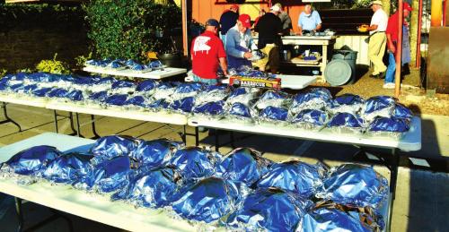 St. James Men’s Club Smokes Turkeys for Family Crisis Center