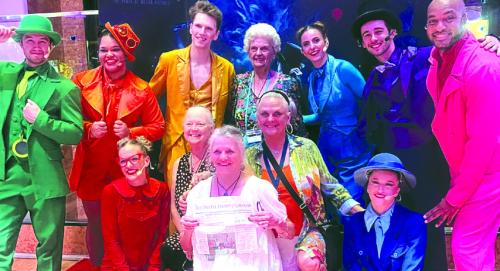 Joyce Schramek of Schulenburg (standing, center) celebrated her 90th birthday on a cruise aboard the Carnival Dream with three of her four daughters. Pictured are center bottom from left are Lorie Kutach, Karen Ross holding a copy of The Fayette County Record, and Debra Blansitt. A tour of Belize City was enjoyed.