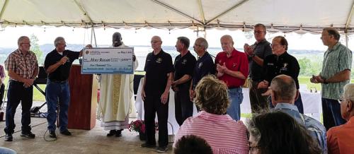 Knights of Columbus Council No. 10333 from Austin presented a $5,000 donation to Queen of the Holy Rosary Catholic Parish in Hostyn to assist with the church’s rebuilding efforts. The Austin KC members presented the donation during the Hosty May Fest picnic on May 7.