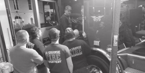 The members of the La Grange Fire Department tour, left, and then pose, right, by the new fire truck.