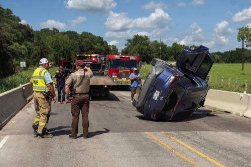 An SUV driver escaped serious injury in a rollover on SH 159 near the Jersey Barnyard. Photo by Andy Behlen