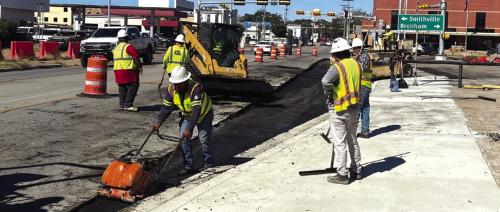 Contractors for the Texas Department of Transportation laid down some pavement Friday for the intersection widening project at Travis St. and Jefferson St. in La Grange. Photo by Andy Behlen