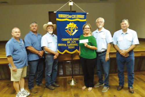 Knights of Columbus Chromcik Council No. 2574 presented Curtis Zwahr $1,500. Zwahr is the La Grange ISD School resource police officer whose wife Jessica died of cancer earlier this year, leaving behind two children. Receiving for Curtis is Janet Bayer. Knights of Columbus members presenting left to right are Marcus Recek, Larry Sulak, Jim Kothmann, Garry Schellberg and Anthony Kristek.