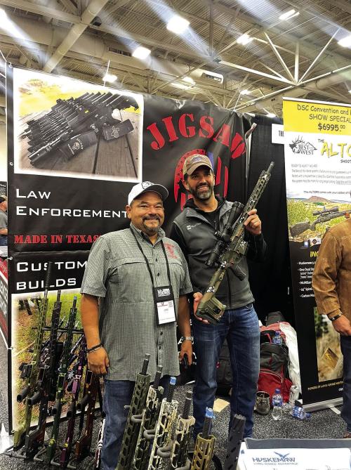 Joe Garza (left), owner of Jigsaw Weaponry, presented Donald Trump Jr. (right) with a new custom rifle at the Dallas Safari Club Expo last week.