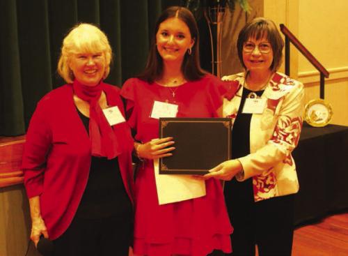 Amalia “Molly” Rorschach, center, was one of the Student Writing Showcase winners for her essay on Rozine Tilicek. Left is program MC Elota Patton. Right is LWV program coordinator Helen Niesner.