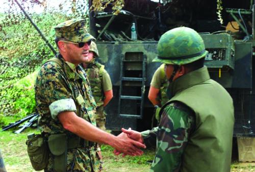 US Marine Corps General Joseph F. Weber (left), Commanding General, 3rd Marine Division, greets a Master Sergeant from the Royal Thai Marines in Pong Nam Ran, Thailand, during an exercise in 2003.