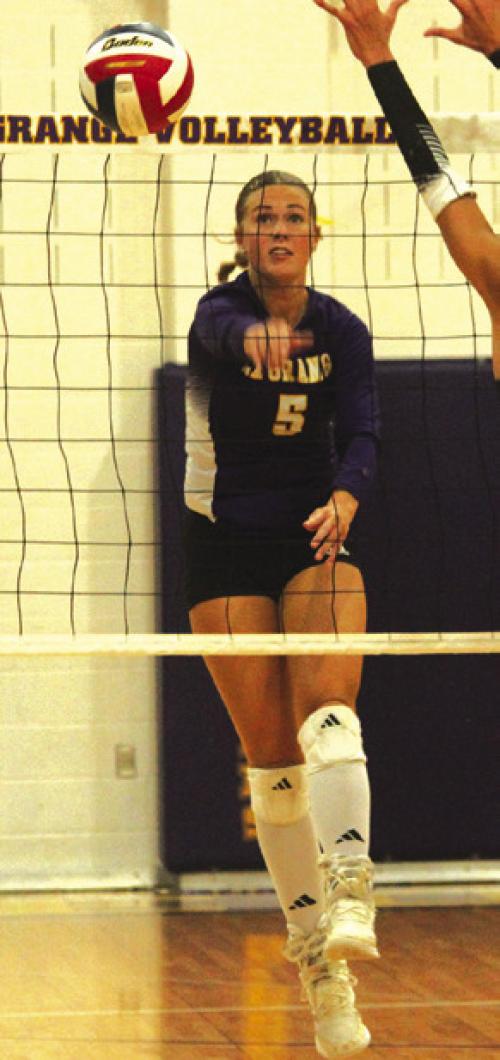 La Grange’s Campbell Cooper spikes a ball past a blocker earlier this season. Photo by Jeff Wick