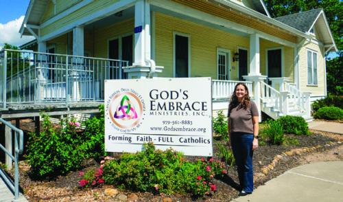 Stacy Oeding, the new executive director of God’s Embrace Ministries, stands outside her organization’s retreat house in High Hill. Photo by Andy Behlen