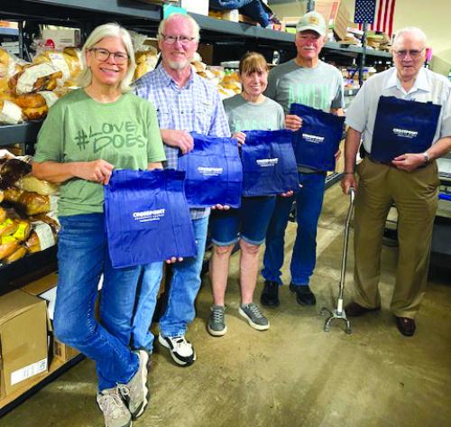 Crosspoint Community Church in La Grange donated 300 reusable bags to the AMEN Food Pantry. Pictured from left are Carol Caddell, Richard Lewis, Marlene Bolton, Roy Bolton, and Jim Smith.