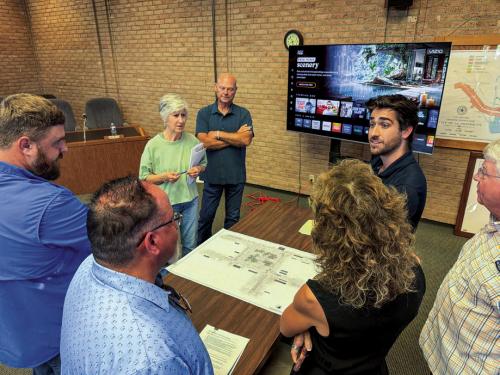 La Grange Main Street Manager Caleb Parks (top right) speaks with members of the public and the Council about the newest downtown parking design. Photo by Andy Behlen