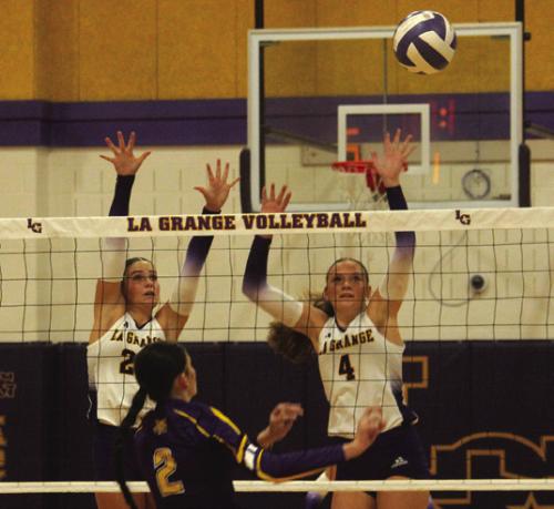 La Grange’s Kyndal Brawley, left, and Avery Griffin, right, jump to try to block a Weimar hit in Tuesday’s win. Photo by Jeff Wick