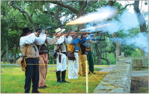 Reenactors fire a volley of rounds at the Monument Hill Remembrance Ceremony on Saturday. Photos by Andy Behlen