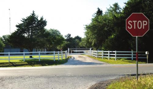 A board fence surrounds Whispering Hills Achievement Center near Flatonia. An investigation into the residential facility for special needs youth revealed allegation of abuse and neglect by staff. Photo by Andy Behlen
