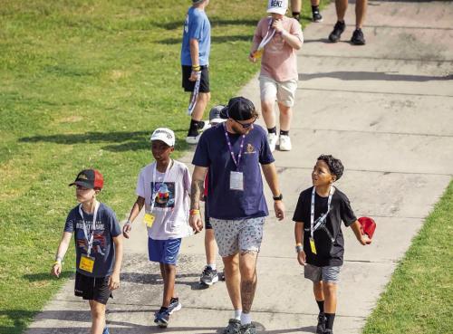 A counselor walks with some of the kids at Camp Periwinkle last week.