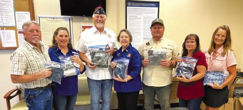Donations through the Veterans Outreach Program sponsored by VFW Auxiliary No. 5254 La Grange were made to the Veterans Clinic in La Grange by (far left) Richard and Becky Leer in memory of Veterans John Leer and Lawrince Heinrich. Helping them present the donations were third from left, Commander Richard Gray and President Marilyn Kothmann, VFW Post and Auxiliary No. 5254 of La Grange, respectively; Roger Heinrich and Ninette Heinrich, children of Lawrince Heinrich; and Barbara Ryza, niece of John Leer.