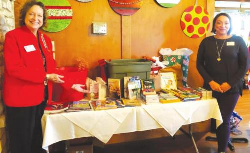 Past Regent Lois Wink presents the chapter’s book donations to Gina Gralinski, Director of the Fayette County Women’s Shelter.