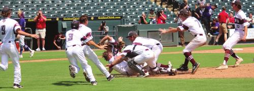 The Lions pile onto one another near the pitcher’s mound after the final out of Thursday’s state title game. Photos by Jeff Wick