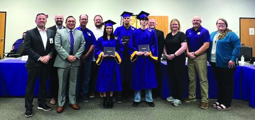 Left to right at Monday’s graduation ceremony – Superintendent Andy McHazlett, high school assistant principal Nathan Truex, high school principal John Pineda, board members Calvin Mersiovsky and Anthony Wessels, graduates Camryn Alvarado, Silvestre Lara-Villegas and Trevor Flood, board members Gary Drab and Karen Roberts, Leopard Academy instructor Brad Harbers and high school counselor Charlee Hernandez. Photo by Regina Keilers