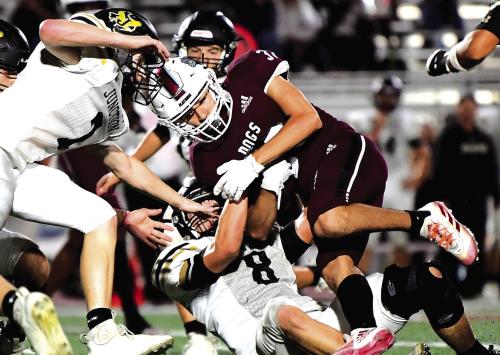 With 2:15 left on the clock in the 3rd quarter, Caysen Perez takes the handoff from quarterback Fidel Venegas and runs to pick up a first down for The Flatonia Bulldogs in Thursday night’s bi-district playoff game in San Antonio. Photo by Stephanie Steinhauser