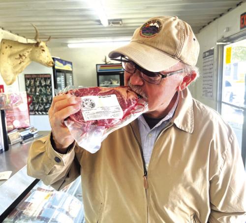 Pancho Howze pretends to take a bite from a steak he bought at Willie Joe’s in High Hill.