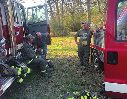 Muldoon firefighters took cover behind their trucks when they thought a property owner was shooting at them during a fire in the Jeddo area last Friday. As it turned out, there were no gunshots. However, the property owner was arrested for criminal mischief and resisting arrest. Photo courtesy of Muldoon VFD