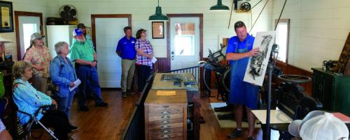 Mark Hermes demonstrates printing inside the newspaper museum on the grounds of the Texas Czech Heritage and Cultural Center Saturday.