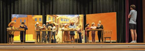 Under the watchful eye of student director Deacon Wick, right, several cast members of “Abandoned Way Out West” rehearse a chaotic pie-making scene last week. Photo by Meadow Taylor-Marklin