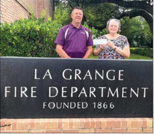 Helping Hands donated $300 from Hermann Sons Life Lodge No. 238 of Plum to the La Grange Volunteer Fire Department. Pictured are Frank Menefee, La Grange Fire Chief, and Linda Poncik.