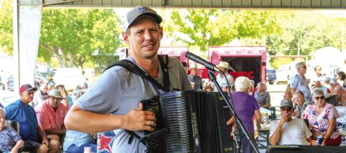 The 168th Annual Prazka Pout, or Praha Picnic, took place on Tuesday, Aug. 15, at The Assumption of the Blessed Virgin Mary Catholic Church in Praha. Above, Garrett Neubauer of The Praha Brothers plays the accordion under the pavilion. Lots more on the picnic is on Page B3 today. Photo by Andy Behlen