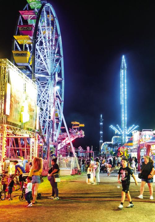 The carnival midway on opening night of the county fair. Photo by Andy Behlen