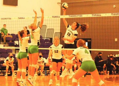 La Grange’s Ryann Marshall leaps above the net to spike this ball in Friday’s playoff game against Burnet. Photo by Jeff Wick
