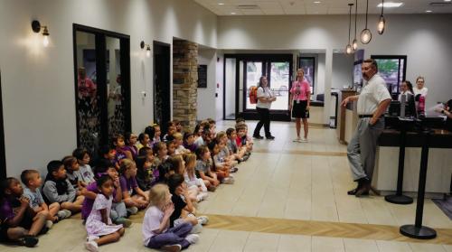 National Bank and Trust President Scott McManus speaks to the kindergarten class about what goes on inside the bank.