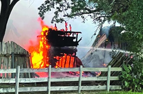 The house was fully engulfed in flames Saturday when firefighters arrived, and the flames were beginning to threaten several nearby homes. The fire had spread to a shed on the property, several trees and a neighbor’s fence.