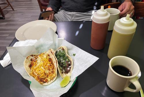 A perfect breakfast at Taqueria Sergio’s in La Grange: a chorizo, egg and cheese taco, a barbacoa taco, and a cup of black coffee. Photo by Andy Behlen