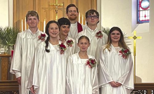 Junior Confirmation was celebrated on Palm Sunday at Holy Cross Lutheran in Warda. Pictured (front, from left:) are Eleanor Carey, Lillian Carey, Kaitlynn Lehmann. Back row: Jay Woelfel, Barrett Kay, Pastor Beck, Vernon Smith IV.