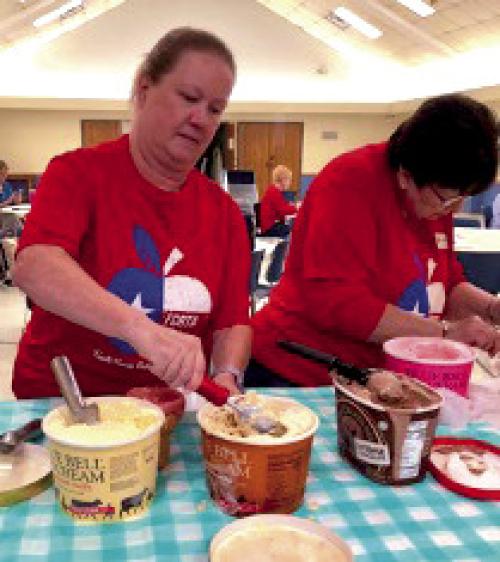Lisa Slinkard and Jeanne Wetjen prepare sundaes with all the fixings.