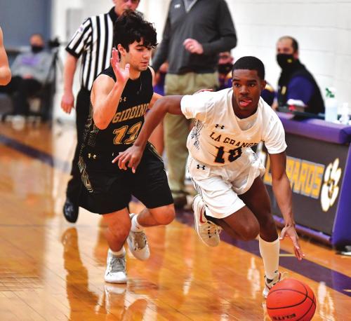 La Grange’s Jordan Scott dribbles the ball in Friday’s game as a Giddings player pursues. Photo by Stephanie Steinhauser
