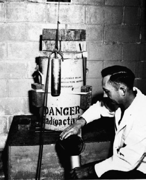 Entomology Research Branch, Insects Affecting Man and Animals Section, Agricultural Research Service, United States Department of Agriculture. “Photograph Loading an Irradiation Chamber with Screw-Worm Pupae.” Special Collections, USDA National Agricultural Library. Accessed June 13, 2026, https://www.nal.usda. gov/exhibits/speccoll/ items/show/7333.