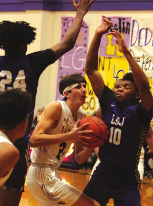La Grange’s Jaxon Cooper tries to get between a pair of Austin LBJ defenders. He scored a team-high 24 points. Photos by Jeff Wick