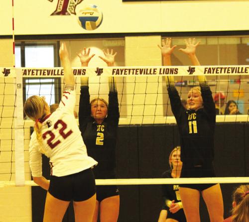 Round Top-Carmine’s Tess Eilers (2) and Jessica Rohde (11) jump to try to block this hit by Fayetteville’s Tara Vitek in Tuesday’s match. Photo by Jeff Wick