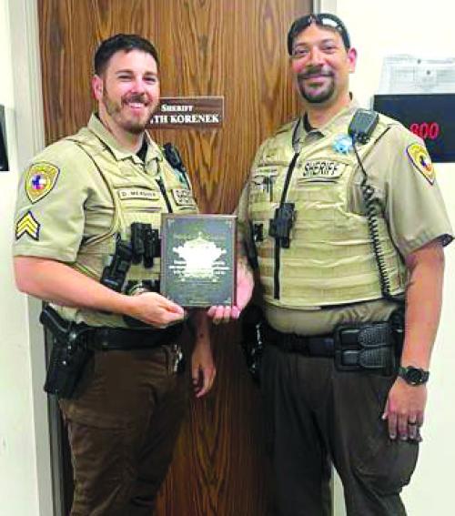 Presenting Deputy Stansberry with his Deputy of the First Quarter plaque is Sergeant Duane Meagher on the left.