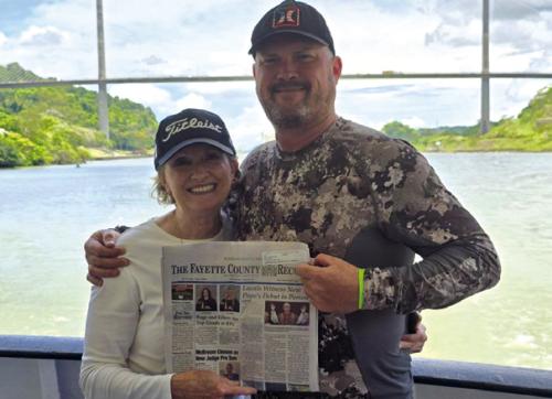 Warda resident Karen Stephenson met her son, Clinton, who lives in Costa Rica, in Panama City, Panama, and took a day cruise through the Panama Canal to Colon aboard the Pacific Queen. The Centennial Bridge is in the background in the photo. She proudly took along the Fayette County Record and is wearing the Titleist cap she won at the neighborhood gathering at the church picnic grounds a couple of years ago.
