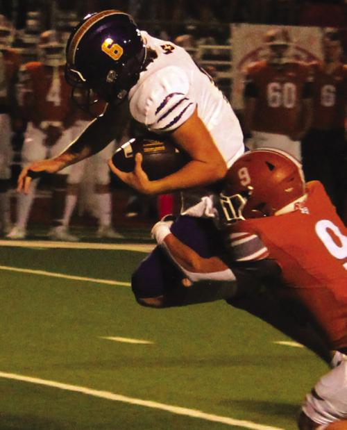 La Grange quarterback Clayton Cooper leaps forward with a Caldwell player hanging into him. Cooper threw for 306 yards and ran for 90 as the Leps beat the Hornet by 21 points. Photo by Jeff Wick