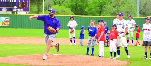 Last Saturday’s Little League Opening Ceremonies was washed out by the weather but there was still some opening week pageantry for the young ballplayers Wednesday as Little League Night was held in conjunction with the Leps varsity baseball game. The youngsters got to go on the field with the players for the National Anthem before La Grange Little League President Jake Kellen, above, threw out the ceremonial first pitch. Photo by Jeff Wick