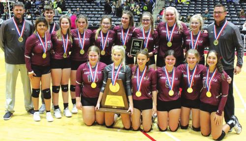 The members of the Fayetteville volleyball team pose with their title trophy and gold medals on the court at the Culwell Center in Garland after winning the 1A state title Thursday. Photo by Jeff Wick